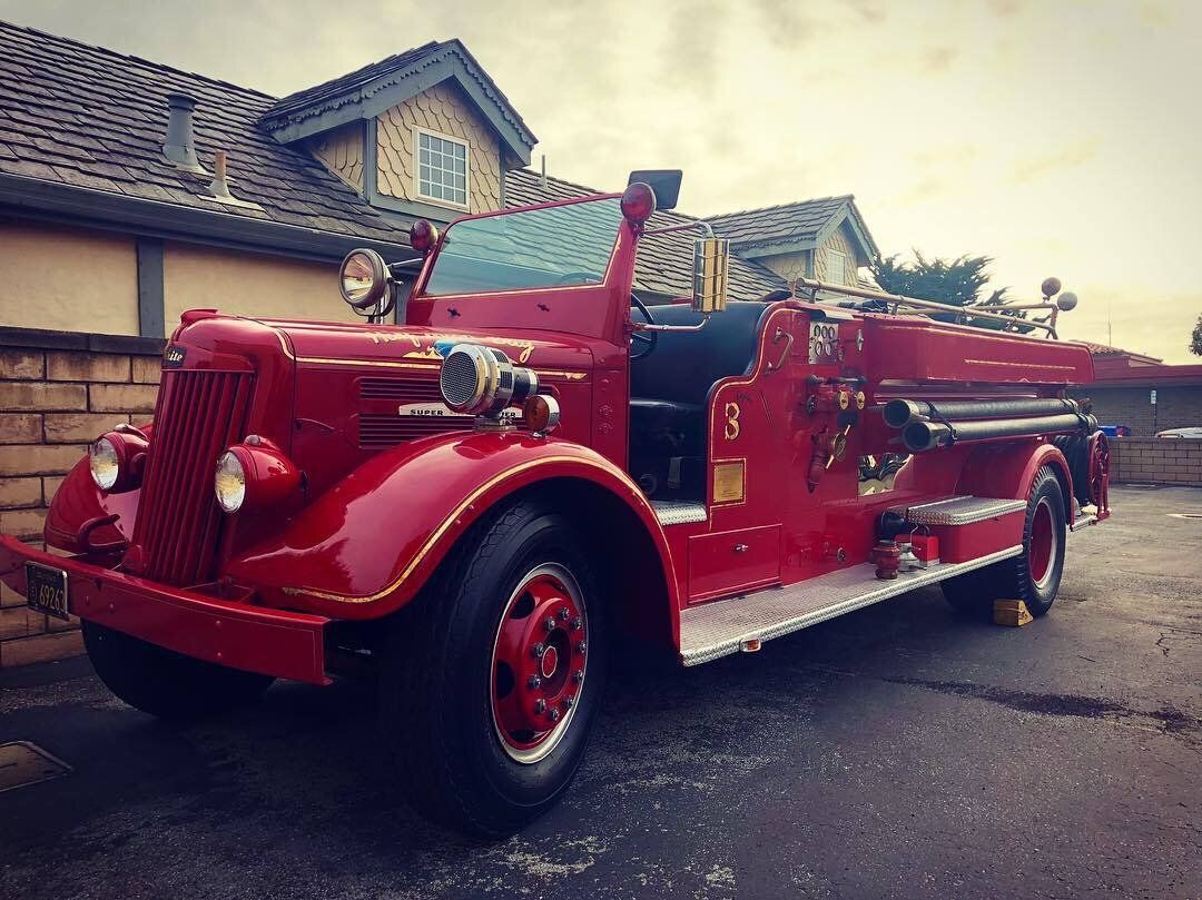 Restored vintage Half Moon Bay fire engine number 3, painted red with gold trim